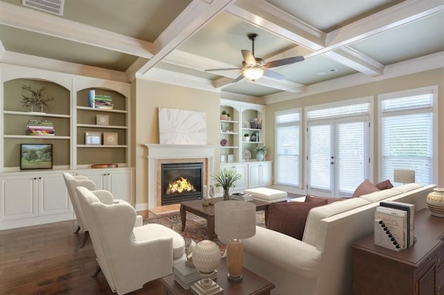 living room with beamed ceiling, coffered ceiling, dark hardwood / wood-style floors, and built in shelves