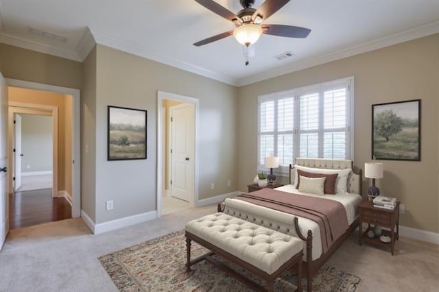 bedroom with ornamental molding, light carpet, and ceiling fan