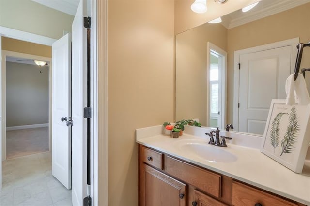 bathroom featuring ornamental molding and vanity