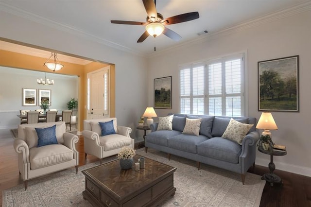 living room featuring crown molding, ceiling fan with notable chandelier, and light wood-type flooring