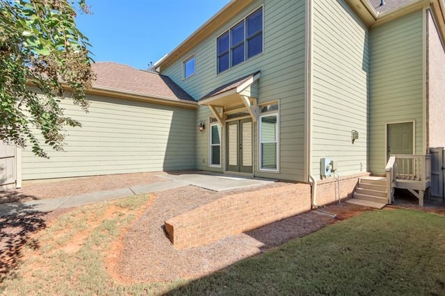 back of house featuring a yard and a patio area