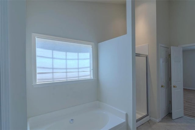 851 Roget Ct, Lawrenceville, GA 30045 - full bathroom with a garden tub, a stall shower, and tile patterned flooring