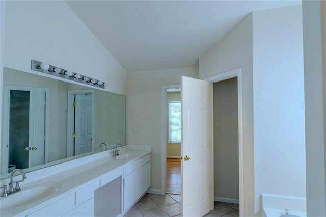 851 Roget Ct, Lawrenceville, GA 30045 - full bathroom with double vanity, tile patterned flooring, and a bath