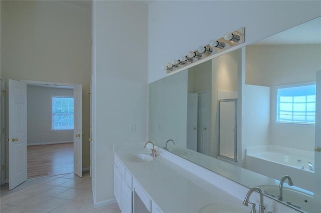 851 Roget Ct, Lawrenceville, GA 30045 - bathroom featuring tile patterned flooring, a bath, double vanity, and a stall shower