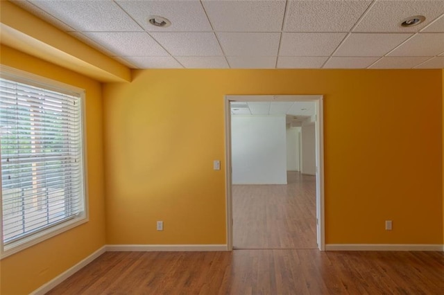 851 Roget Ct, Lawrenceville, GA 30045 - unfurnished room featuring wood finished floors, healthy amount of natural light, and a drop ceiling