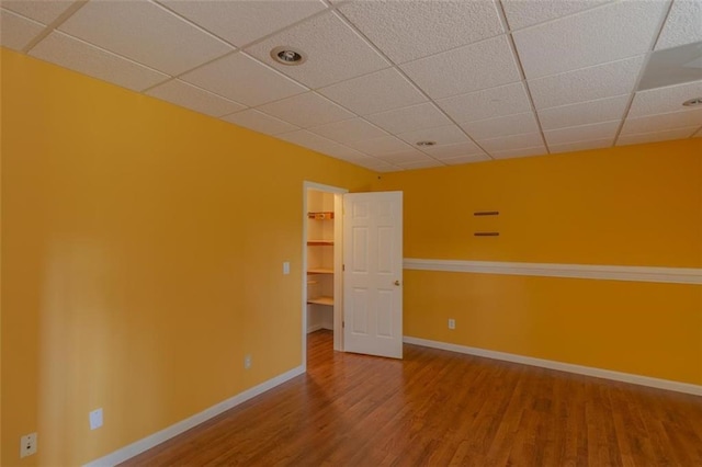 851 Roget Ct, Lawrenceville, GA 30045 - empty room with wood finished floors and a paneled ceiling