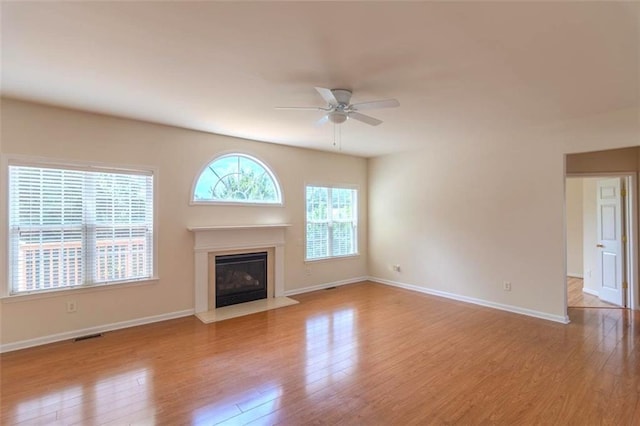 851 Roget Ct, Lawrenceville, GA 30045 - unfurnished living room featuring a ceiling fan, wood finished floors, and a fireplace with flush hearth