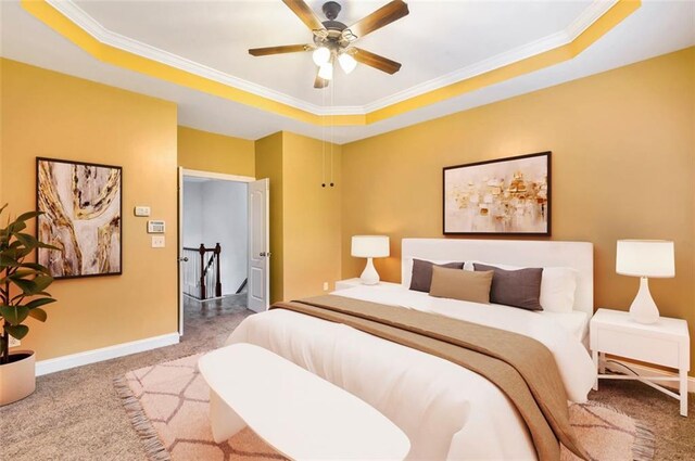 275 Blue Pointe Ct, Suwanee, GA 30024 - bedroom featuring crown molding, light carpet, a tray ceiling, connected bathroom, and baseboards