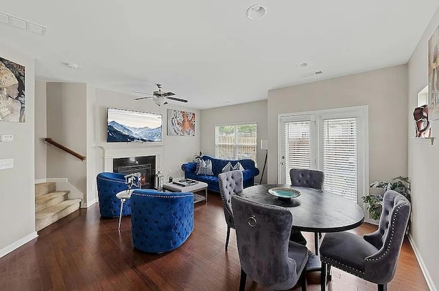 5076 Longview Walk, Decatur, GA 30035 - dining space with stairs, wood finished floors, a glass covered fireplace, ceiling fan, and visible vents