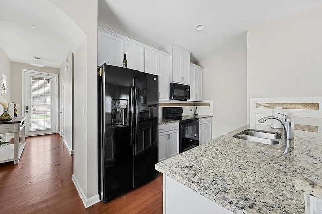 5076 Longview Walk, Decatur, GA 30035 - kitchen with light stone counters, a sink, black appliances, and dark wood-style flooring