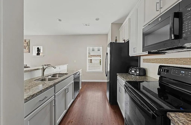 5076 Longview Walk, Decatur, GA 30035 - kitchen with a sink, black appliances, decorative backsplash, baseboards, and light stone countertops