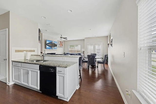 5076 Longview Walk, Decatur, GA 30035 - kitchen with a sink, light stone countertops, a peninsula, black dishwasher, and dark wood-style flooring