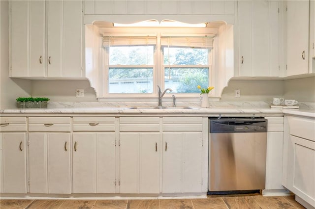 kitchen featuring dishwasher, white cabinets, and sink