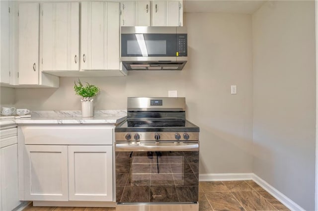 kitchen with white cabinetry and appliances with stainless steel finishes