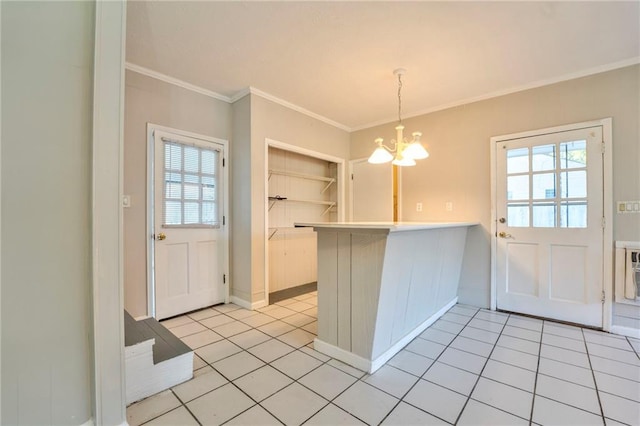 kitchen featuring crown molding, hanging light fixtures, light tile patterned floors, a notable chandelier, and kitchen peninsula