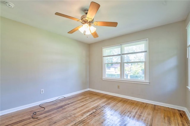 empty room with ceiling fan and light hardwood / wood-style flooring