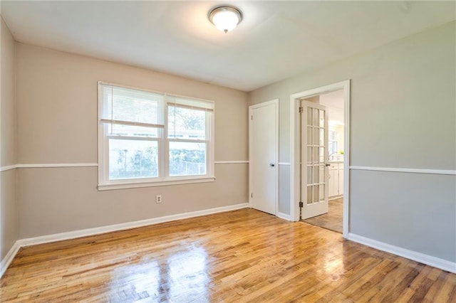 unfurnished room with light wood-type flooring