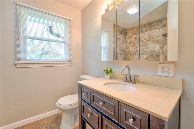 bathroom with tile patterned flooring, vanity, and toilet