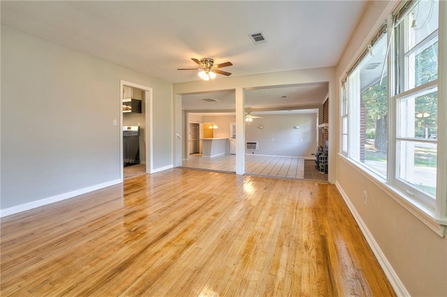 unfurnished living room with ceiling fan and light hardwood / wood-style floors