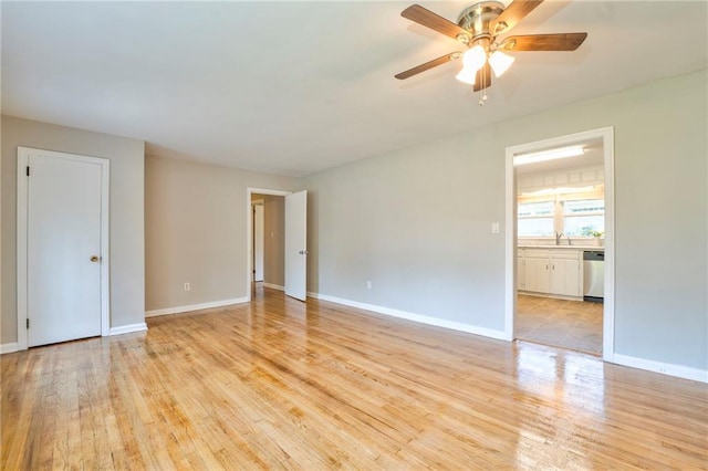 empty room with light hardwood / wood-style floors and ceiling fan