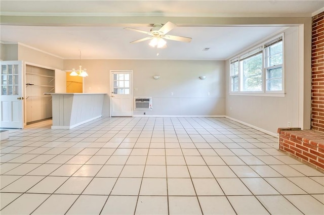 unfurnished living room with built in shelves, ceiling fan with notable chandelier, a wall unit AC, crown molding, and light tile patterned floors