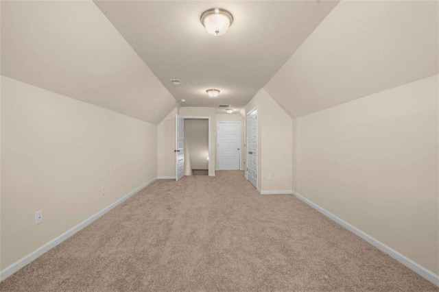 bonus room featuring light carpet, lofted ceiling, and baseboards