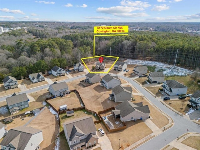 birds eye view of property with a residential view and a view of trees