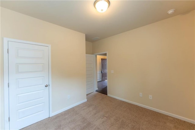 unfurnished bedroom featuring carpet floors and baseboards