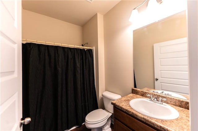 bathroom featuring toilet, a shower with curtain, and vanity