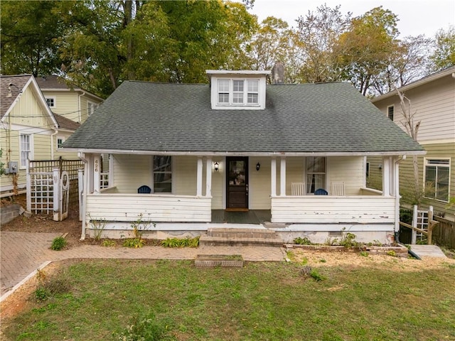 view of front of house with a porch and a front lawn