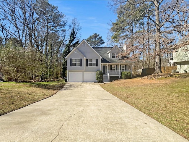 view of front of home featuring an attached garage, covered porch, concrete driveway, and a front yard