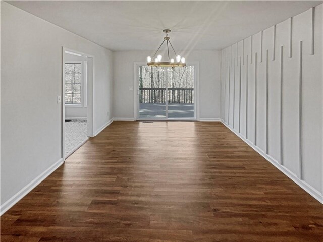 31 Mariner Way SE, Acworth, GA 30102 - unfurnished dining area with dark wood-style flooring, baseboards, and an inviting chandelier