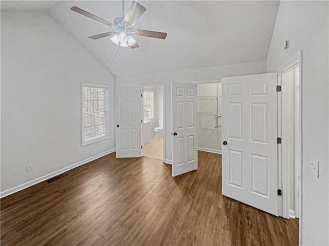 31 Mariner Way SE, Acworth, GA 30102 - unfurnished bedroom with lofted ceiling, visible vents, a walk in closet, and dark wood-style flooring