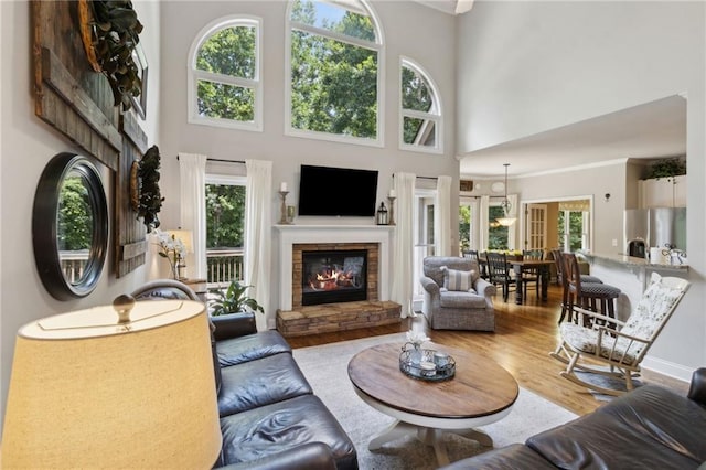 2713 Misty Rock Cv, Dacula, GA 30019 - living room with a stone fireplace, a high ceiling, and wood finished floors