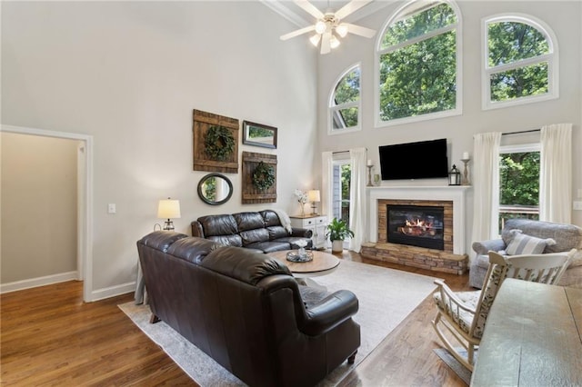 2713 Misty Rock Cv, Dacula, GA 30019 - living area with a high ceiling, a fireplace, wood finished floors, and a ceiling fan