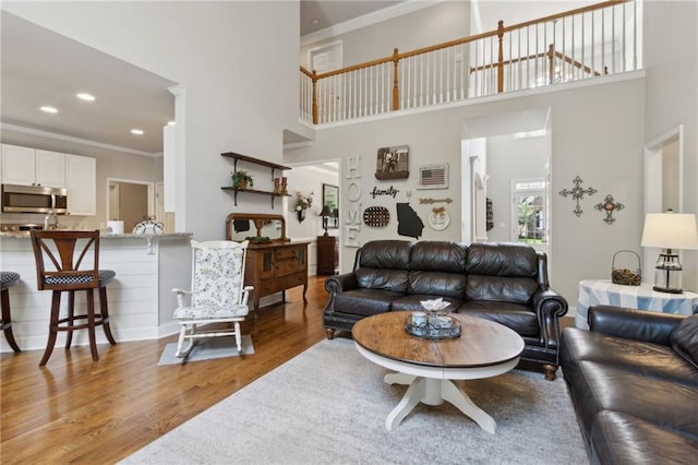 2713 Misty Rock Cv, Dacula, GA 30019 - living area with wood finished floors, a high ceiling, ornamental molding, and recessed lighting