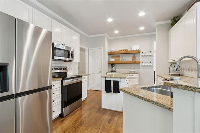 2713 Misty Rock Cv, Dacula, GA 30019 - kitchen with stainless steel appliances, ornamental molding, wood finished floors, decorative backsplash, and light stone countertops