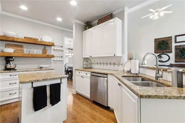 2713 Misty Rock Cv, Dacula, GA 30019 - kitchen with stainless steel dishwasher, crown molding, white cabinetry, light stone counters, and light wood-type flooring