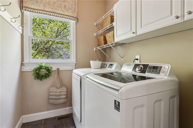 2713 Misty Rock Cv, Dacula, GA 30019 - washroom featuring cabinet space, separate washer and dryer, and dark tile patterned floors