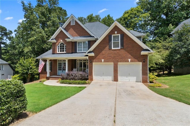 2713 Misty Rock Cv, Dacula, GA 30019 - view of front of house with concrete driveway, a front yard, brick siding, a garage, and a porch
