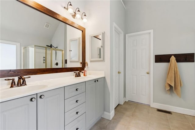 2713 Misty Rock Cv, Dacula, GA 30019 - bathroom featuring double vanity, a shower stall, and vaulted ceiling