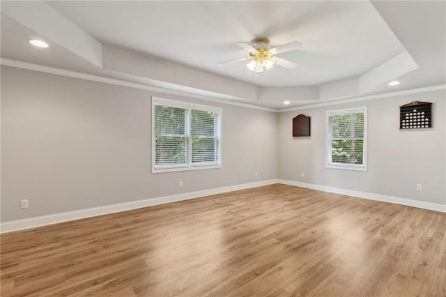 2713 Misty Rock Cv, Dacula, GA 30019 - unfurnished room with a tray ceiling, plenty of natural light, ceiling fan, recessed lighting, and light wood-type flooring