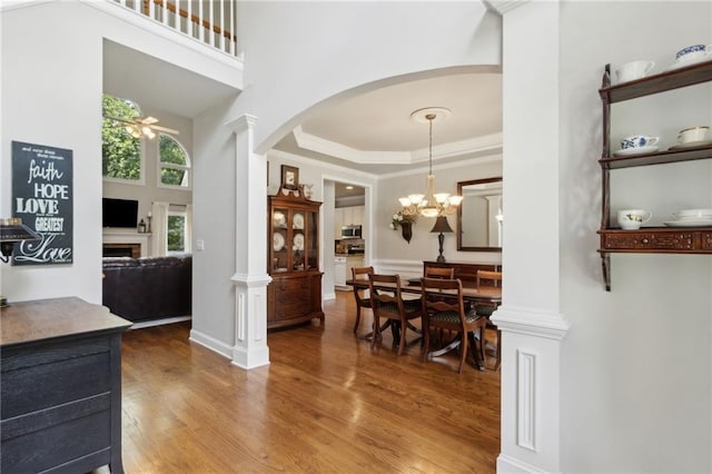 2713 Misty Rock Cv, Dacula, GA 30019 - foyer featuring arched walkways, wood finished floors, a ceiling fan, crown molding, and decorative columns