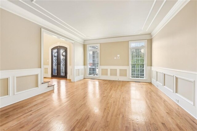 interior space featuring french doors, light hardwood / wood-style floors, and crown molding