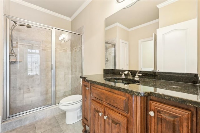 bathroom with tile patterned floors, vanity, toilet, and ornamental molding