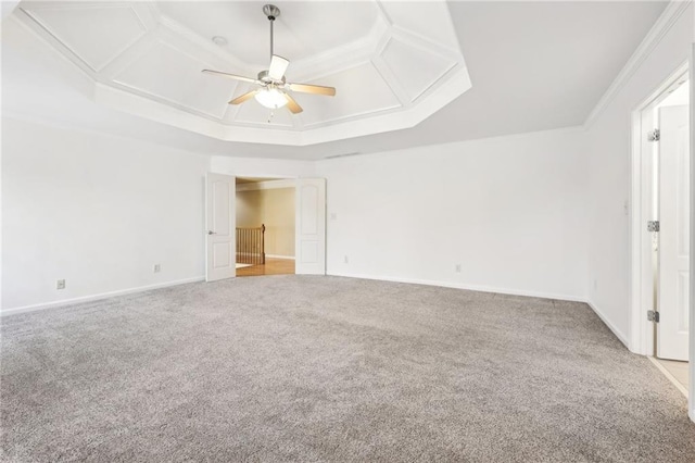 carpeted spare room featuring ceiling fan, coffered ceiling, and ornamental molding