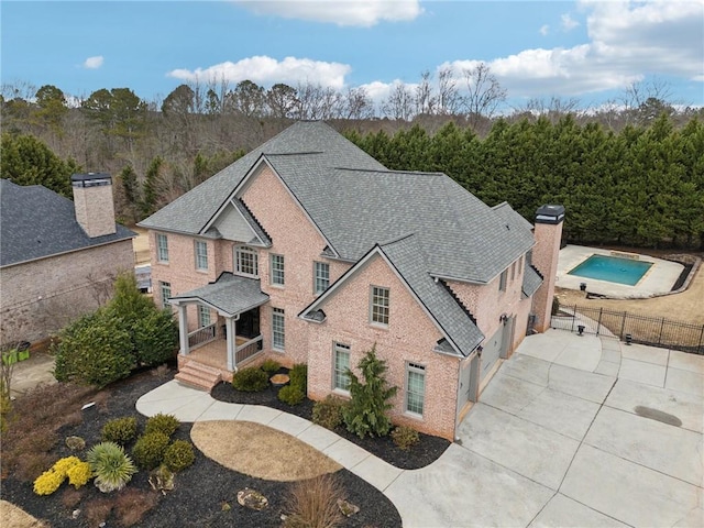 view of front of property with a fenced in pool