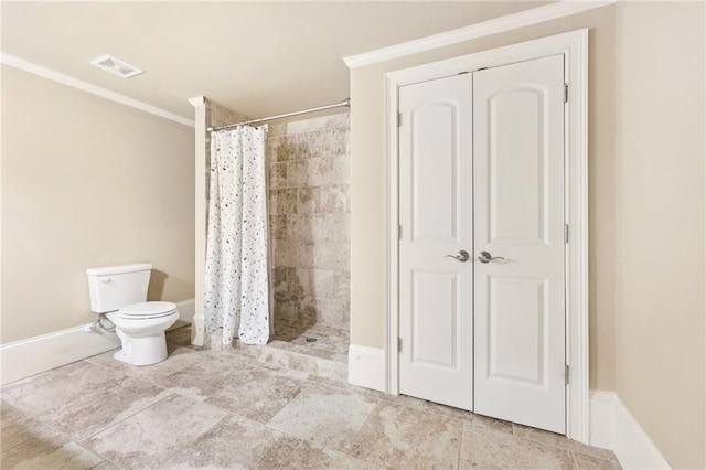 bathroom with toilet, ornamental molding, and walk in shower