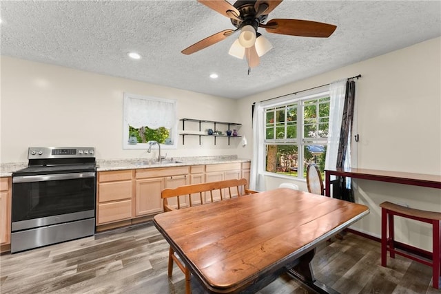 dining area with a textured ceiling, ceiling fan, hardwood / wood-style flooring, and sink