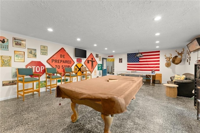 playroom featuring pool table and a textured ceiling